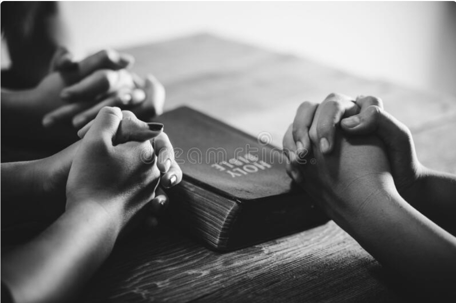 Praying Hands with The Bible